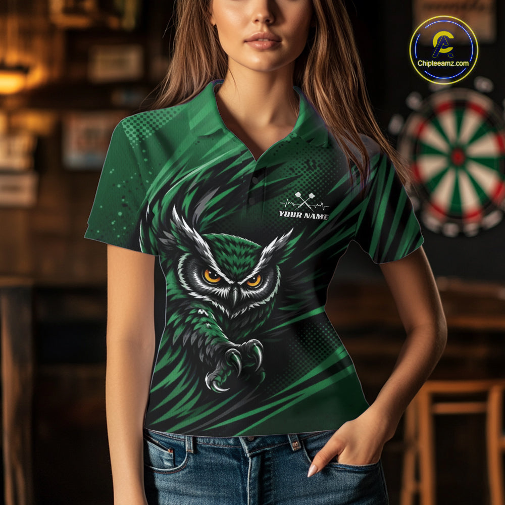 Front view of a woman wearing a green and black darts polo shirt, pairing a striking owl graphic with personalized names, a flying dart, and dartboard.