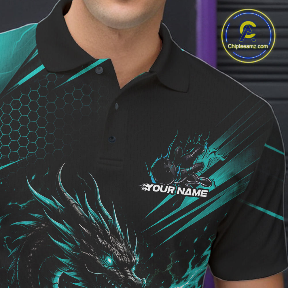 A close-up of a man wearing a black short-sleeve polo shirt with a teal and black dragon graphic, a hexagonal pattern on the shoulder, and a customizable chest print that reads 'YOUR NAME'.