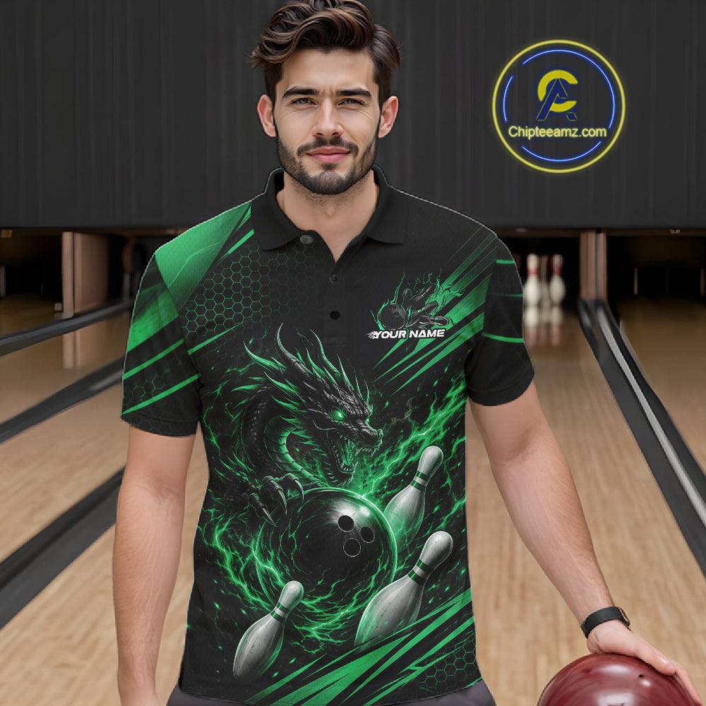 A man wearing a black short-sleeve bowling polo shirt with a green dragon graphic, bowling ball and pins, and the text 'YOUR NAME' on the chest. He is holding a bowling ball in a bowling alley, with a 'Chipteamz.