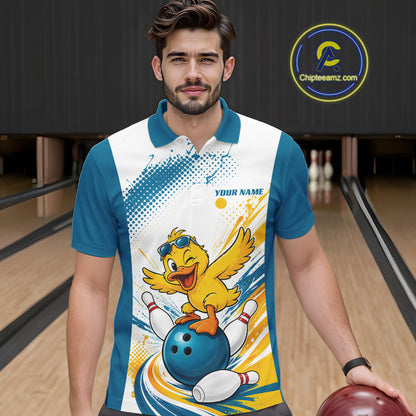 A man in a bowling alley wearing a custom short-sleeve bowling polo shirt with a cartoon duck graphic on the front. The shirt has a white and teal base with a colorful graphic of a yellow duck bowling on a blue ball, with bowling pins and yellow paint splatters.