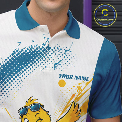 A close-up of a person wearing a custom short-sleeve polo shirt. The shirt has a white body, a teal blue collar and sleeves, and a graphic print featuring a yellow cartoon bird wearing blue sunglasses, blue halftone dots, yellow paint splatters, and the text 'YOUR NAME'.