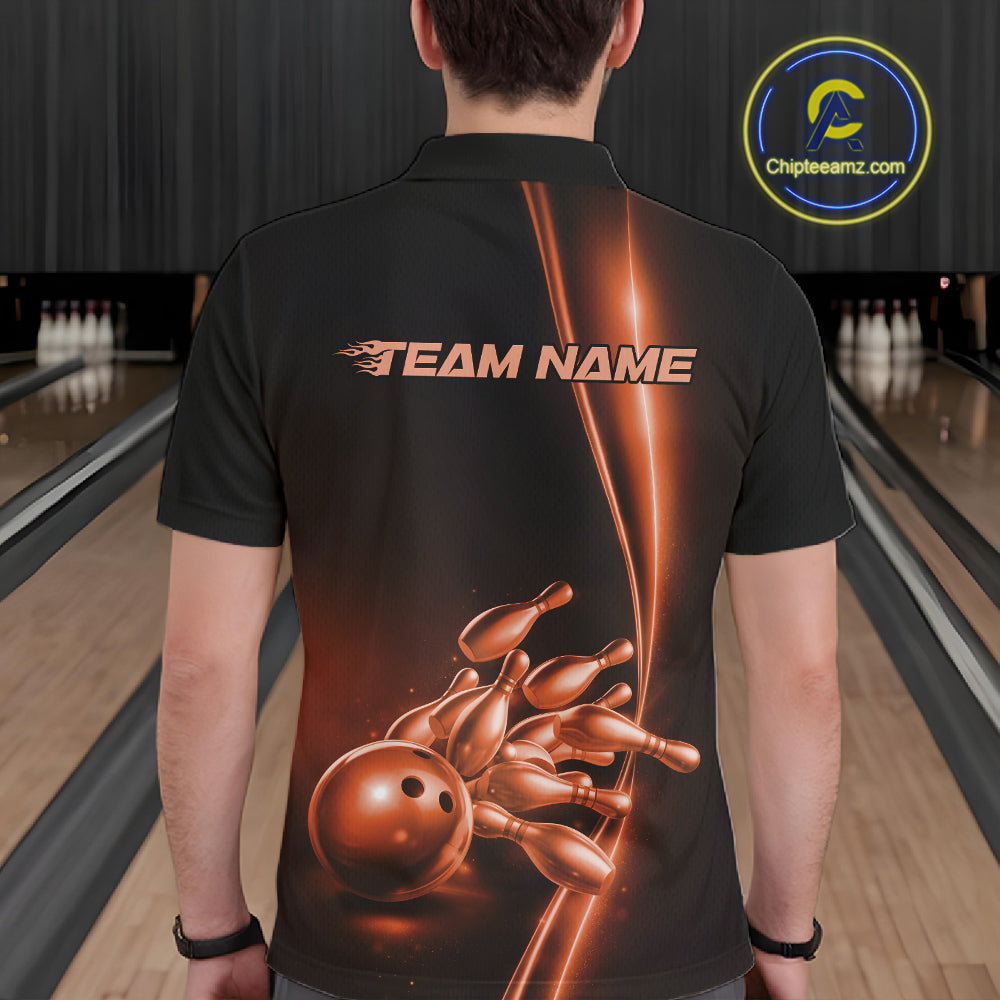 Bowling lane back view male model wearing bowling polo shirt, black base with orange bowling ball and pins graphic, promotional sports atmosphere