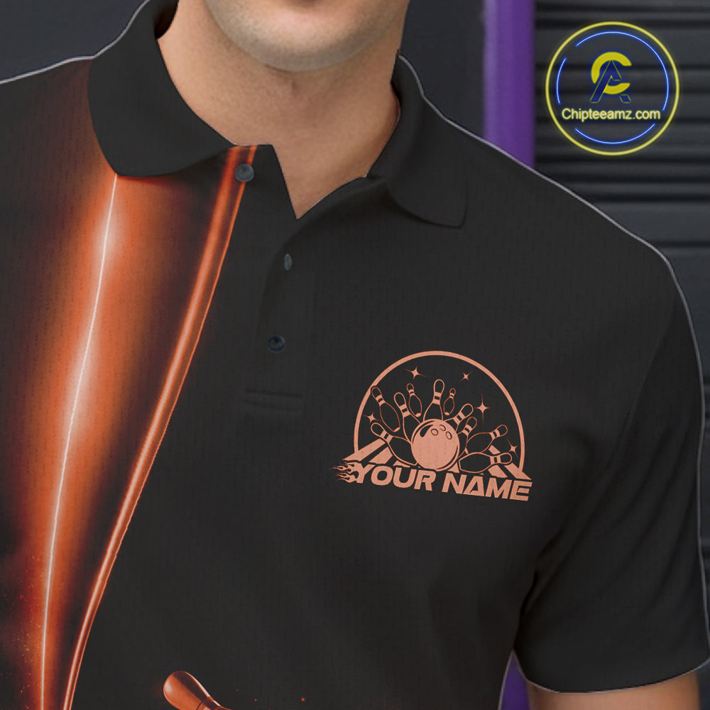 Close up left chest of bowling polo shirt, black fabric featuring orange bowling ball and pins emblem, detailed apparel branding perspective