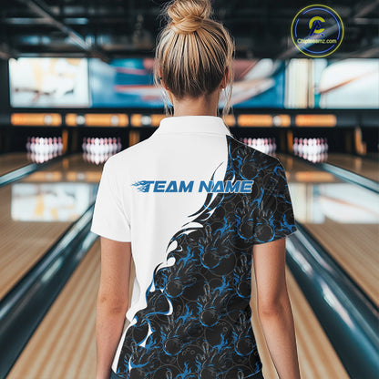 Back view of female model at bowling lane wearing white polo shirt with blue and black flame bowling pattern, inside bowling venue, relaxed stance