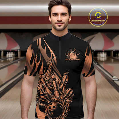 Male model seen front view in a bowling lane wearing a black quarter zip shirt featuring rose gold gradient tribal flame with bowling ball striking pins design.