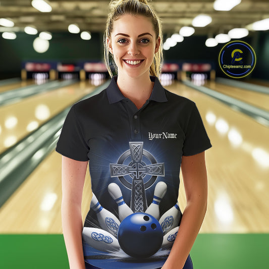 Female model front view in bowling lane wearing black polo shirt with blue Celtic cross and bowling ball exploding into pins artwork