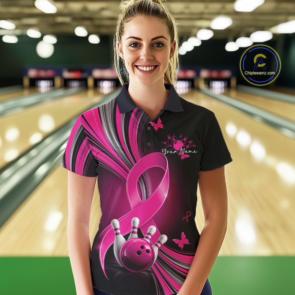 Front view of a female model in a black and pink bowling polo with breast cancer awareness ribbons, small butterflies, and bowling graphics