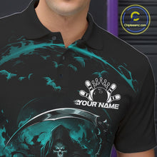 Load image into Gallery viewer, Close-up of the left chest on a black and cyan blue bowling polo shirt featuring a grim reaper commanding a blazing bowling ball crashing into scattered pins through swirling flames.