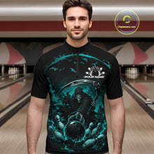 Load image into Gallery viewer, Male model shown from the front wearing a black and cyan blue bowling quarter zip shirt with a grim reaper reaching through swirling flames to command a blazing bowling ball striking scattered pins in a bowling lane.