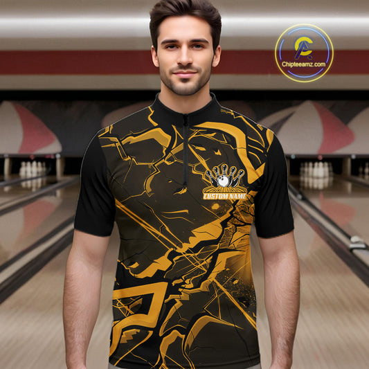 Male model at a bowling lane wearing a black and yellow quarter-zip with futuristic cracked geometric graphics.