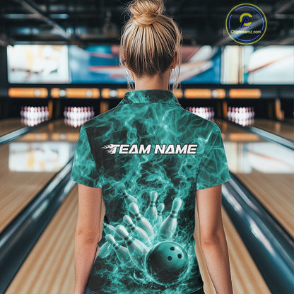 Back view of a quarter-zip shirt showcasing a turquoise blue bowling ball striking pins amid flame-inspired graphics.