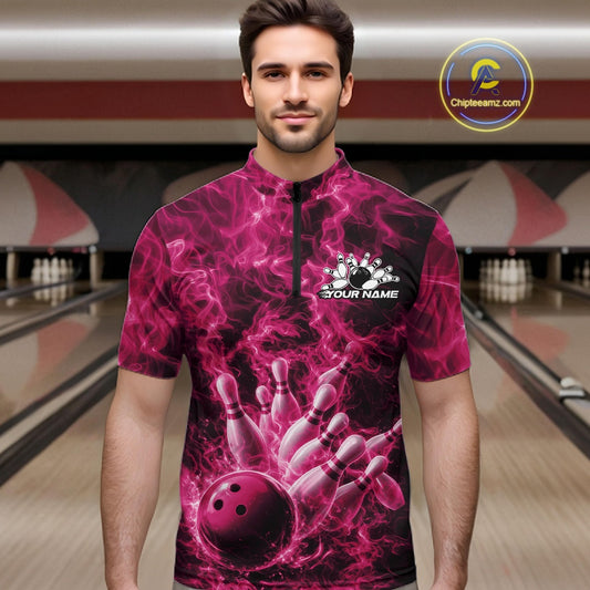 Male model wearing a bowling quarter-zip in a bowling lane with a pink bowling ball striking pins and fiery graphics.