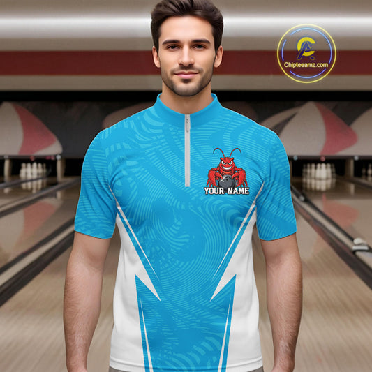 Front view of a male model in a bowling alley wearing a blue custom quarter-zip bowling shirt with a funny aggressive crawfish holding a bowling ball in a sportswear-style design.
