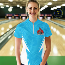 Load image into Gallery viewer, Front view of a happy female model in a bowling alley wearing a blue custom quarter-zip bowling shirt with a funny aggressive crawfish holding a bowling ball in a sportswear-style design.