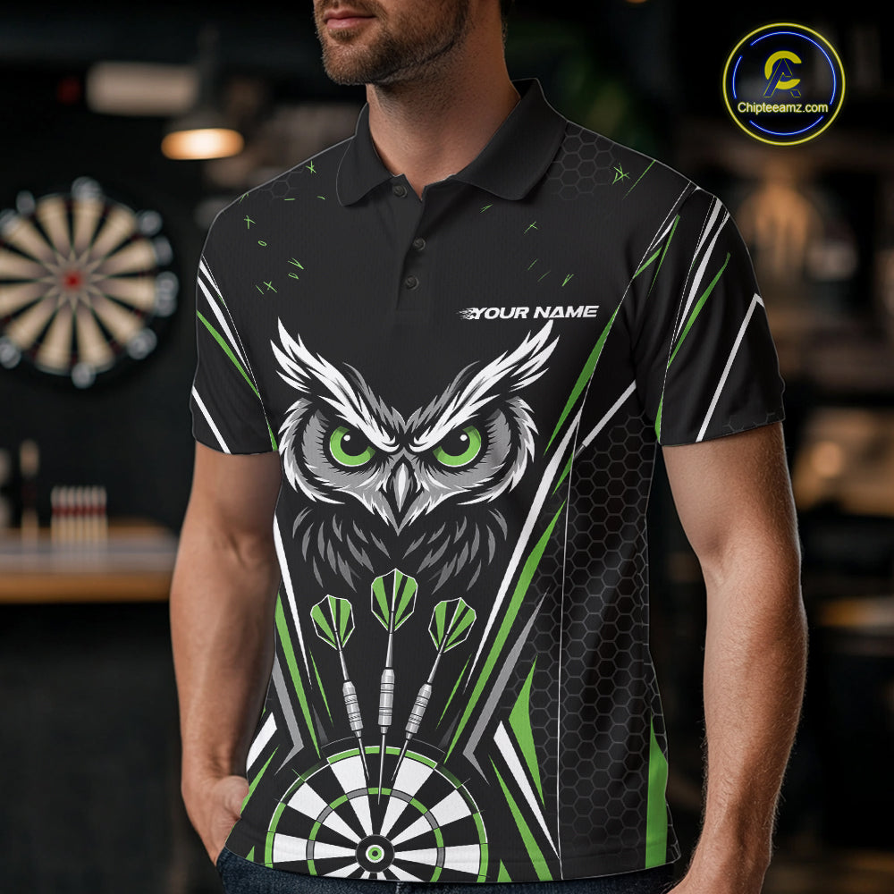 Front view of a man wearing a black darts polo shirt with green accents, featuring fierce owls framed by dartboards, three darts, and personalized name areas.