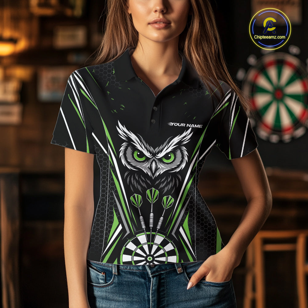 Front view of a woman wearing a black darts polo shirt with green accents, featuring fierce owls framed by dartboards, three darts, and personalized name areas.