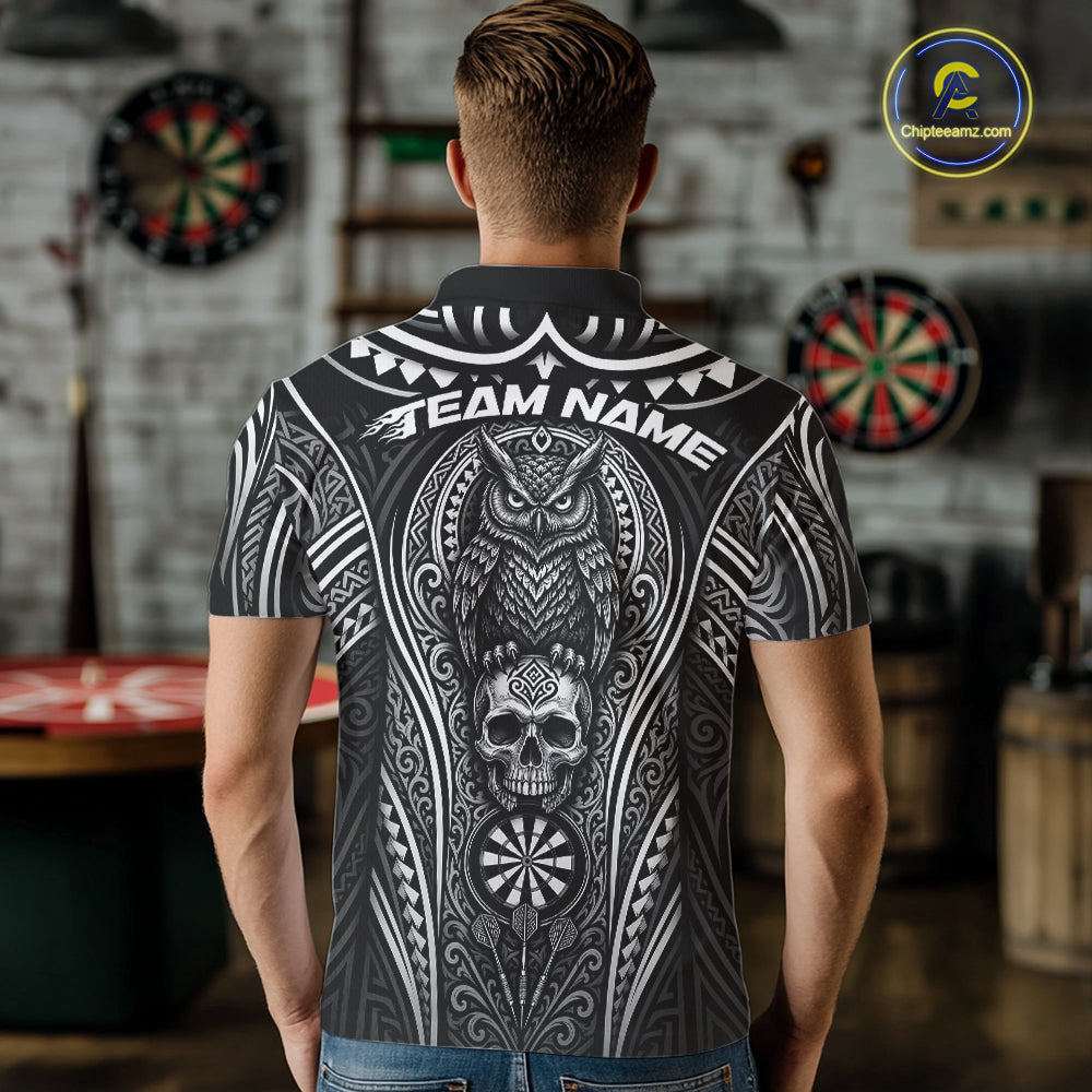 A man viewed from behind wearing a black short-sleeve polo shirt with an all-over white tribal-style graphic print featuring an owl, skull, dartboard