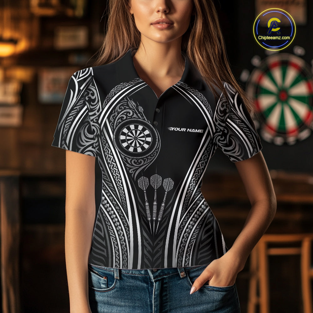 A woman wearing a black short-sleeve polo shirt with a white tribal-inspired graphic pattern, dartboard motifs