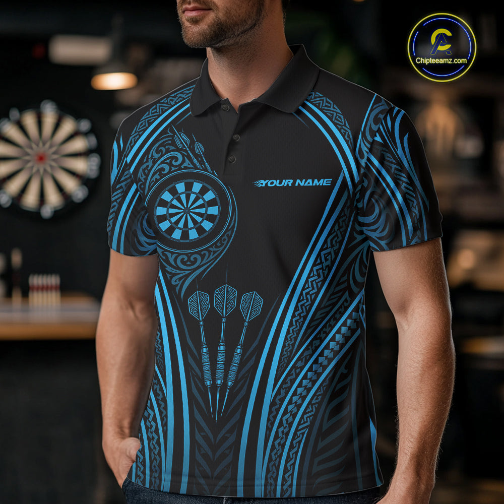 A man wearing a black short-sleeve polo shirt with a blue Polynesian tribal pattern, featuring a dartboard graphic on the chest and three darts. 