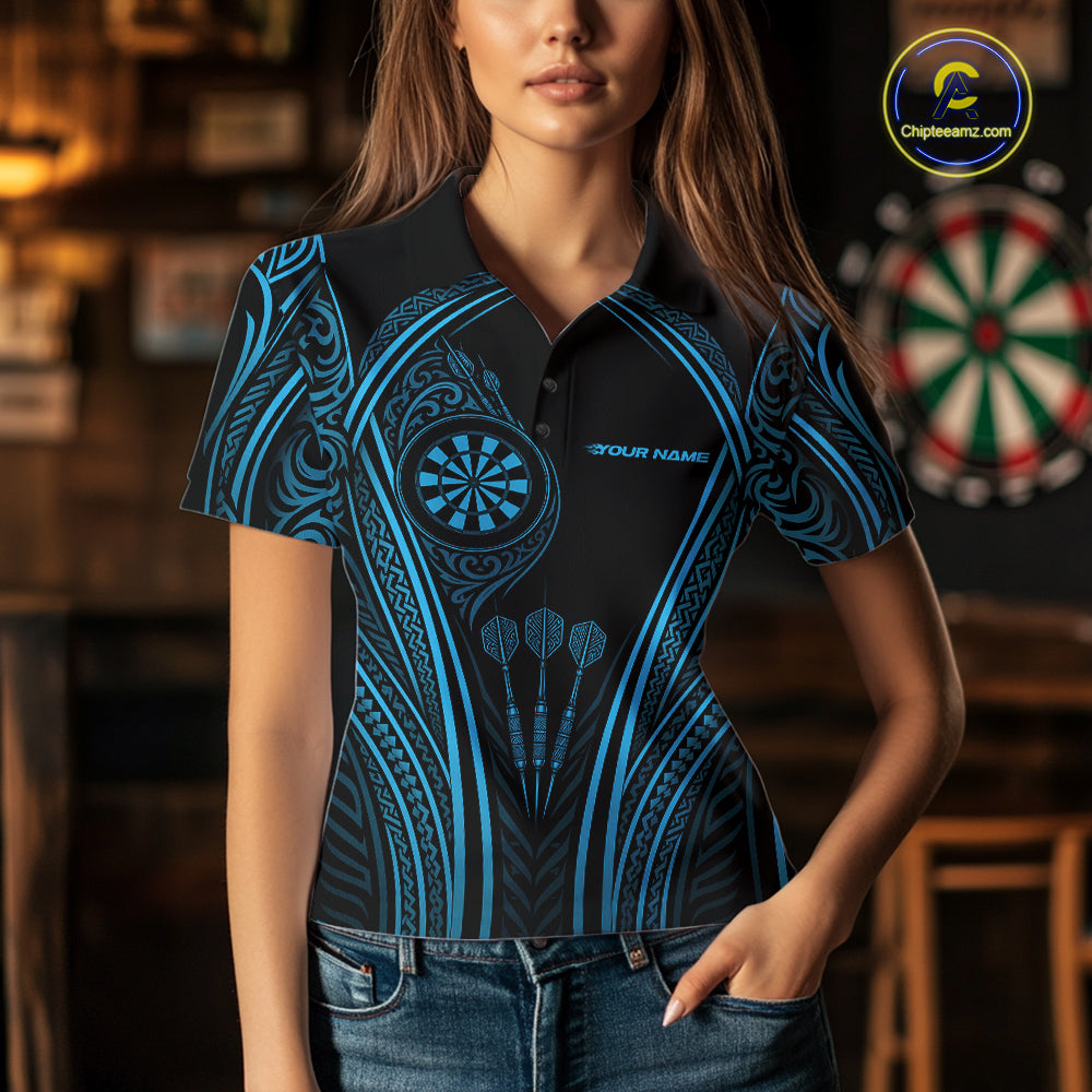 A woman wearing a short-sleeve polo shirt with a black and bright blue tribal-inspired pattern, featuring a dartboard graphic 