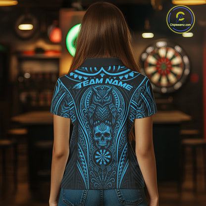 A woman viewed from behind wearing a short-sleeve shirt with a large blue and black graphic print featuring an owl, skull, and dartboard motif. 