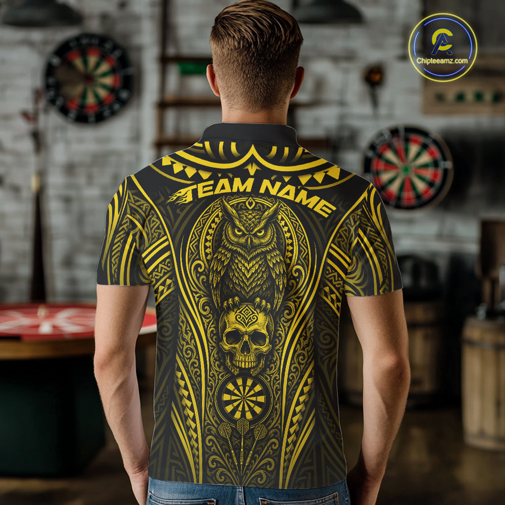 A man viewed from behind wearing a short-sleeve polo shirt with a large yellow and black tribal-style graphic featuring an owl, skull, dartboard motif, and the text 'TEAM NAME'. 