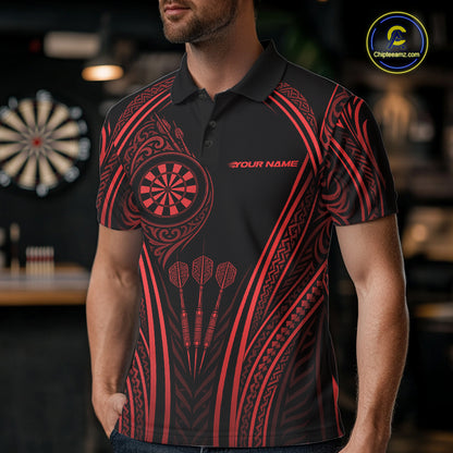 A man wearing a black short-sleeve polo shirt with a red Polynesian tribal pattern, featuring a dartboard graphic on the chest and three darts printed on the front. 