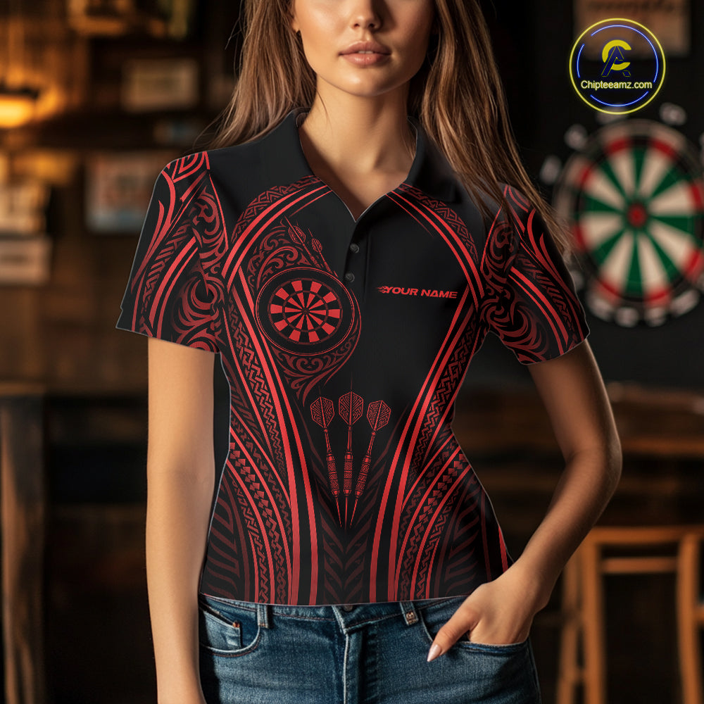 A woman wearing a black short-sleeve polo shirt with a red tribal-inspired dartboard pattern and the text 'YOUR NAME' on the chest