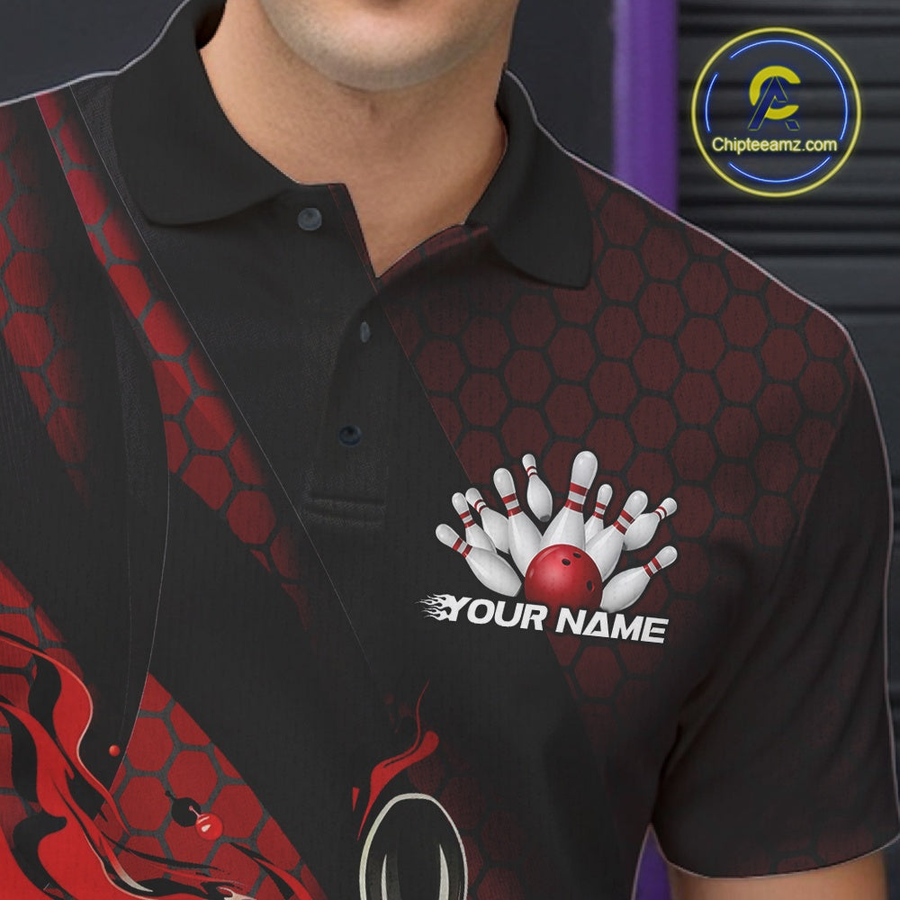 Close-up of the left chest on a black and red bowling polo shirt featuring a flaming bowling ball and pin artwork with diagonal stripe details.