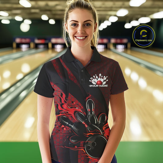 Female model wearing a black and red bowling polo shirt at a bowling lane with fiery bowling action artwork and geometric styling.