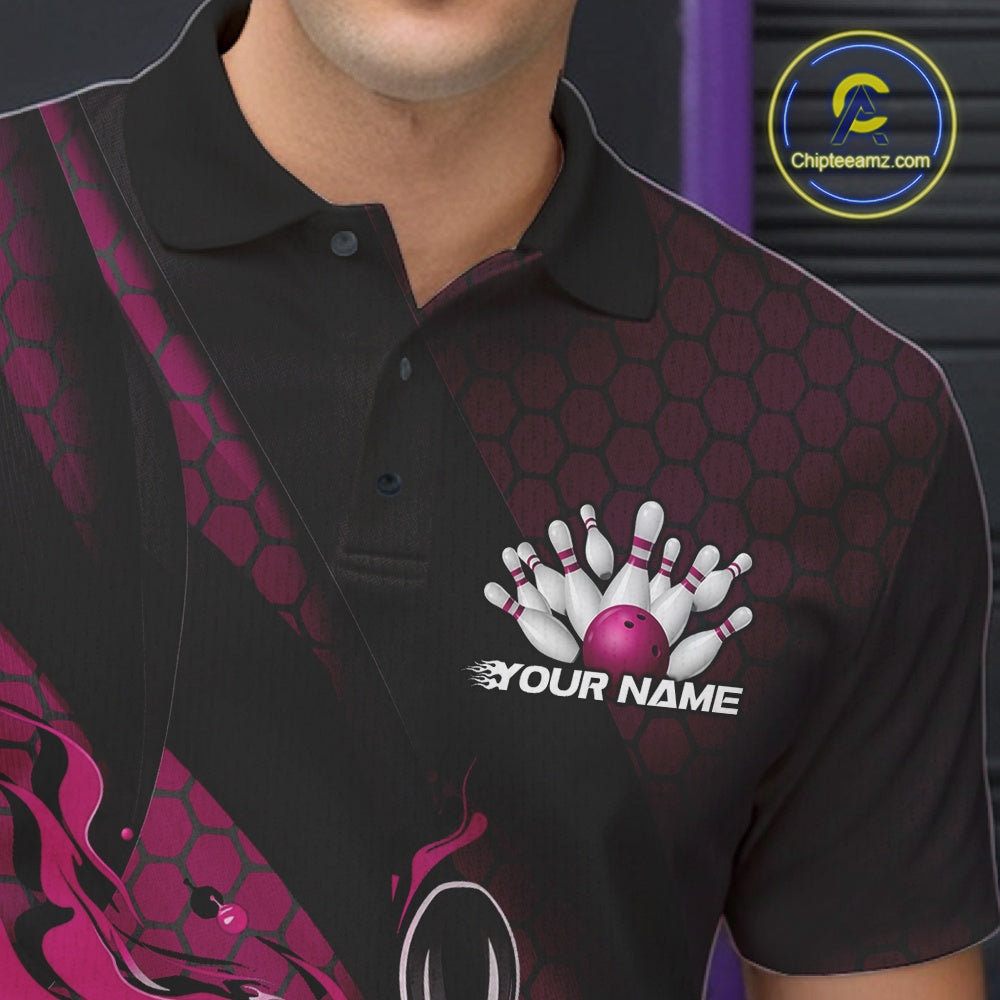 Close-up left chest view of a black and pink bowling polo shirt featuring a flaming bowling ball striking pins with hexagon details.