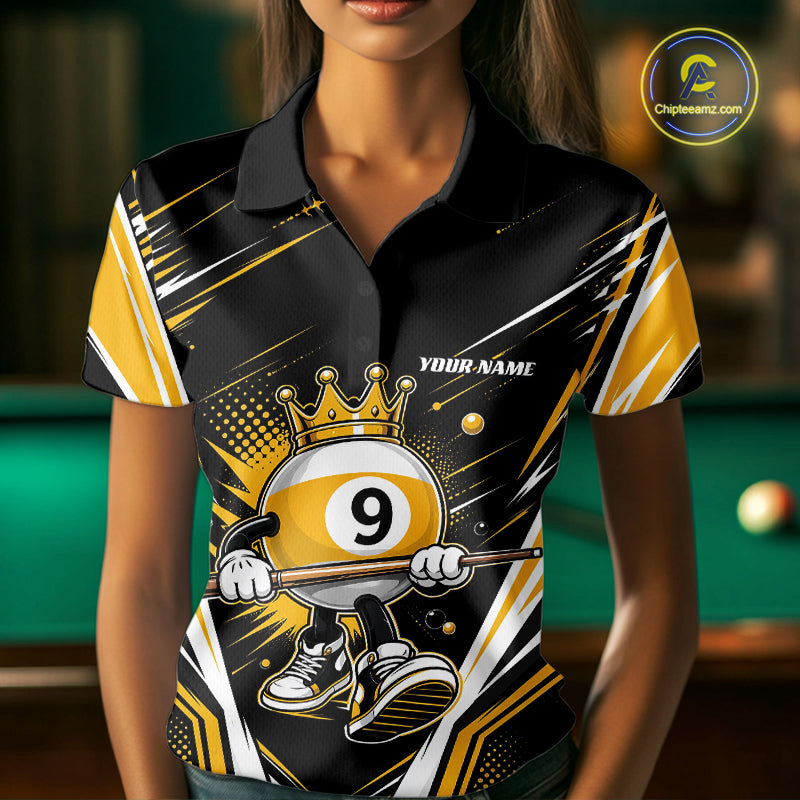 A woman wearing a custom black and gold polo shirt with a 9-ball cartoon graphic and 'YOUR NAME' text, set against a blurred green pool table background.