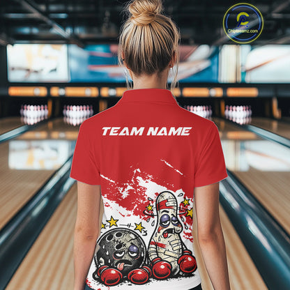 Back view of a female bowler in a red and white quarter-zip shirt, cartoon boxing bowling ball and pin artwork highlighted on back design.