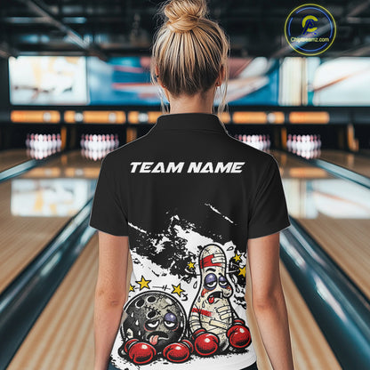 Back view of a female bowler in a black and white quarter-zip shirt, playful boxing bowling ball and pin artwork across the back panel.