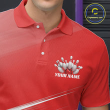 Load image into Gallery viewer, Close up left chest view of a red bowling polo shirt with bowling ball and pins artwork blended into a pink geometric pattern.