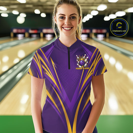 A female model wearing a purple and yellow bowling polo shirt featuring a crowned bowling ball and bowling pins.
