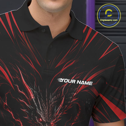 A man wearing a black short-sleeve polo shirt with a red and black bowling-themed graphic print, standing in a bowling alley holding a bowling ball. 