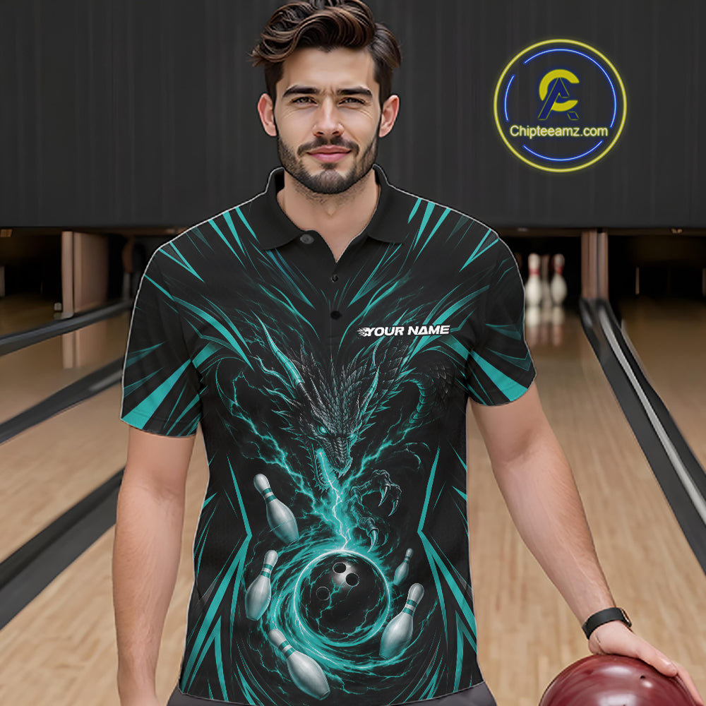 A man wearing a black short-sleeve bowling-themed polo shirt with a teal and black dragon abstract graphic design, standing in a bowling alley holding a bowling ball.
