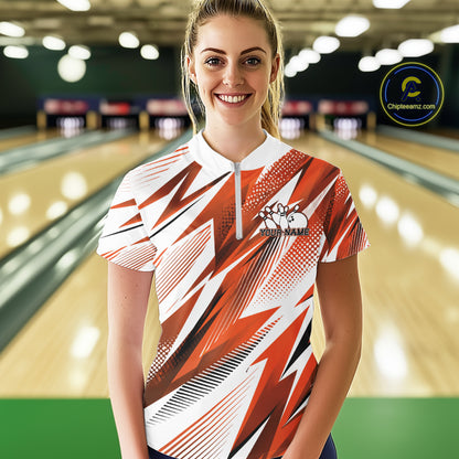 Woman wearing a red and white bowling shirt with a pattern in a bowling alley.