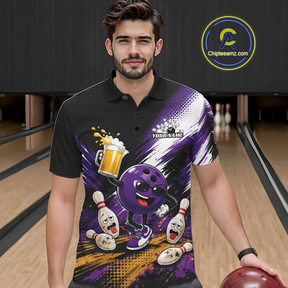 A man wearing a black short-sleeve polo shirt with a vibrant purple, white, and yellow bowling-themed graphic print, standing in a bowling alley holding a bowling ball. 