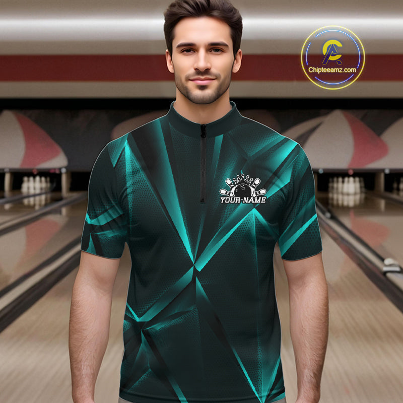 Man wearing a green bowling shirt with a logo and text in a bowling alley.