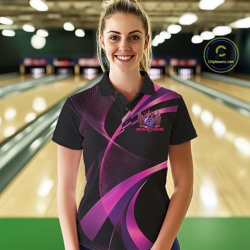 Woman wearing a black and purple bowling shirt with a logo on a bowling alley background
