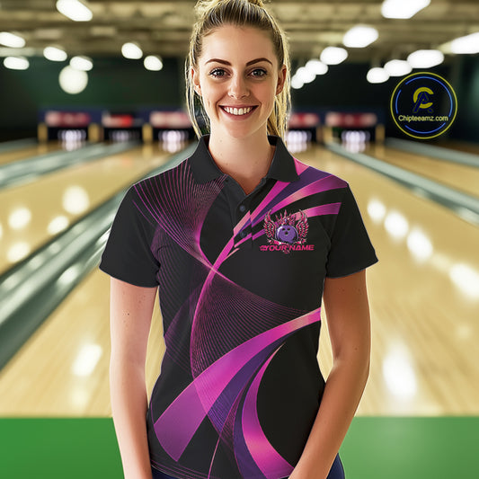 Woman wearing a black and purple bowling shirt with a logo on a bowling alley background