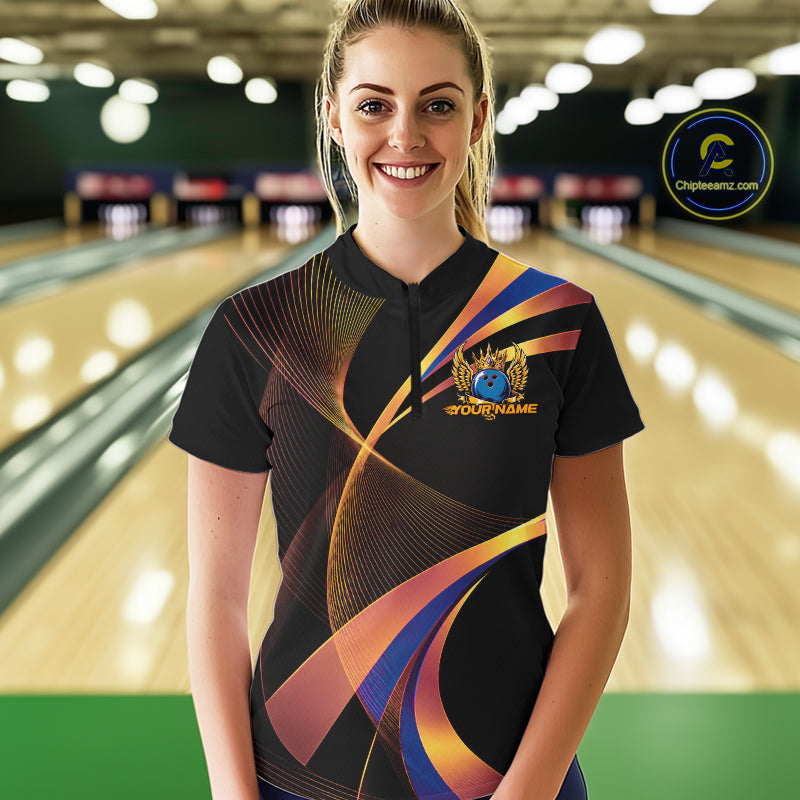 Woman wearing a colorful bowling shirt with a logo in a bowling alley.