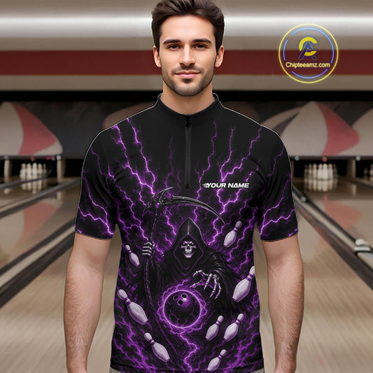 A man wearing a black short-sleeve quarter zip shirt bowling jersey with a purple lightning and grim reaper graphic, standing in front of a blurred bowling alley background. 