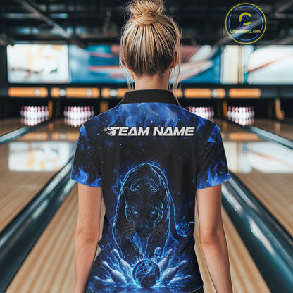 Back view of a female model in a bowling lane wearing a black quarter-zip shirt featuring glowing blue electric panther artwork with bold bowling action scene.