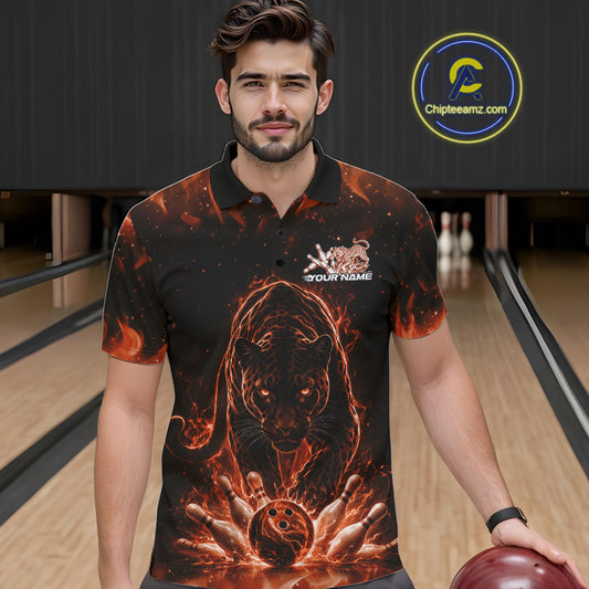Front view of a male model in a bowling lane wearing a black polo shirt with glowing orange electric panther and bowling ball crashing through pins dynamic sports graphic.