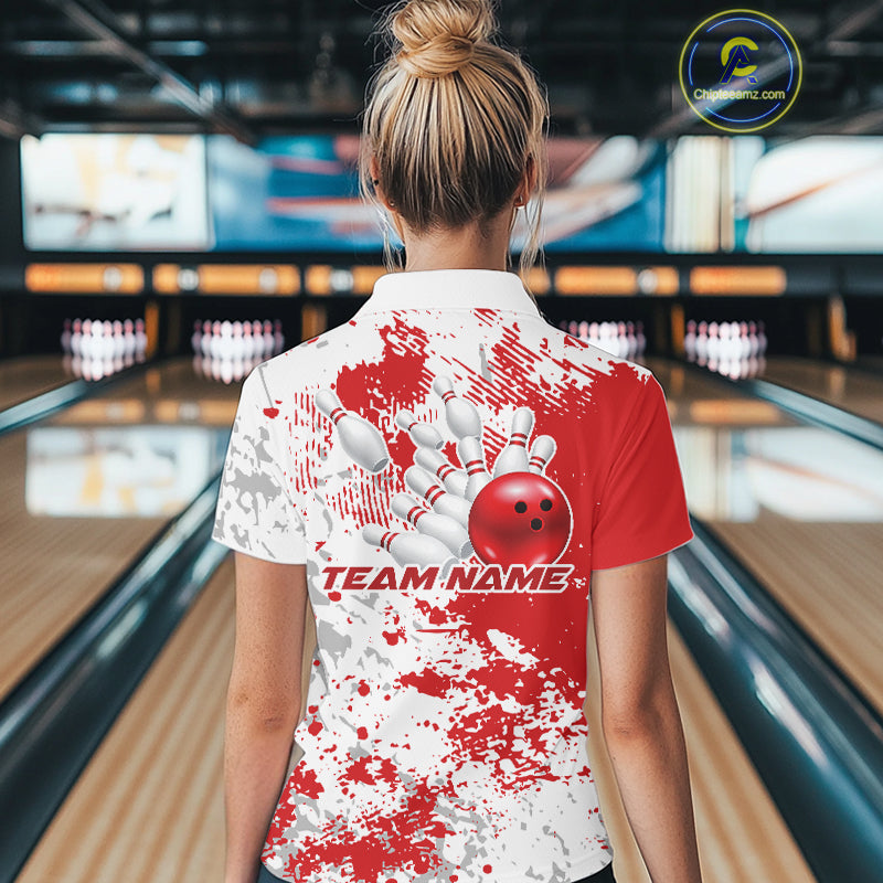 Back view female model at bowling lane wearing white polo with red and white splatter background, relaxed pose in bowling venue