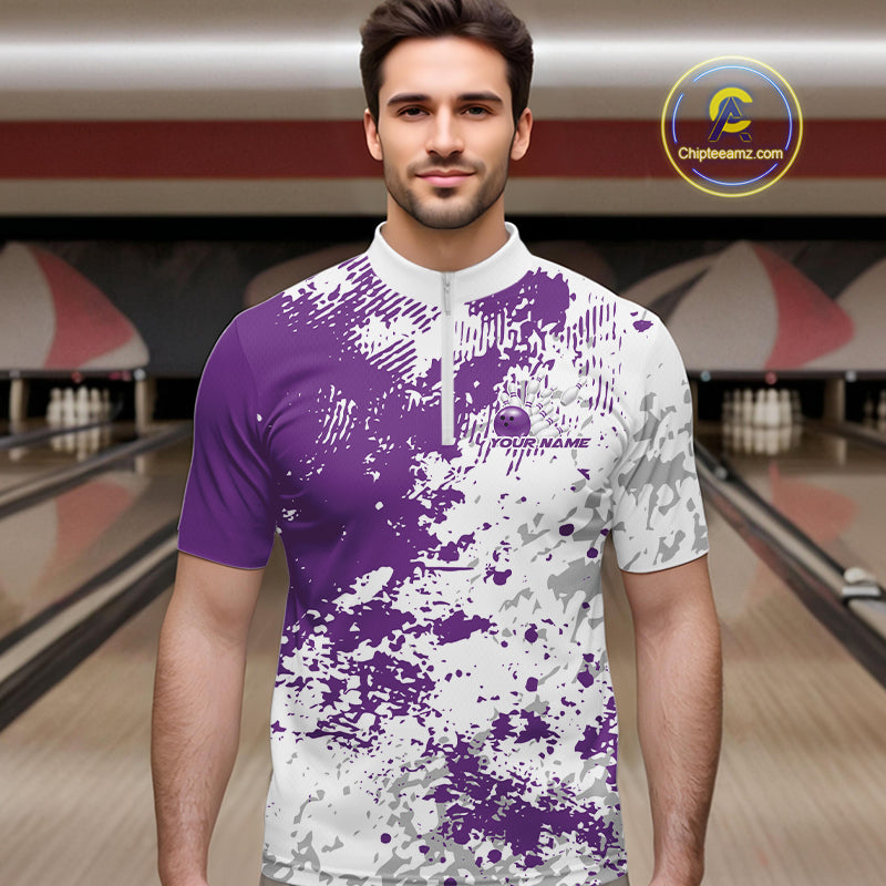 Male model at a bowling lane wearing purple and white quarter zip shirt, front view featuring abstract splatter design with modern athletic look