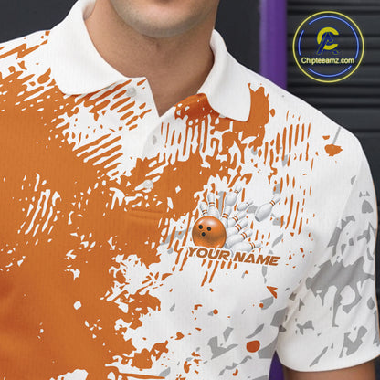 Close-up view of the left chest of an orange and white splatter bowling polo shirt featuring minimal abstract bowling design detail.